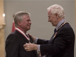 Philippe Kirsch, at left, is invested in the Order of Canada in 2010. Kirsch was the first president of the International Criminal Court and a key player in its creation. Can Canada now help save the court?