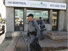 Ottawa Police carry out a black bag during raid on an illegal pot shop, Green Tree Medical Dispensary at 290 Montreal Rd. in Vanier Friday, November 4, 2016. It was part of a crack down on at least five of the city's 17 illegal pot shops.