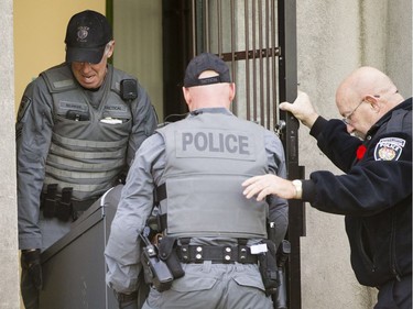 Ottawa Police carry out an ATM machine during a raid on an illegal pot shop, Green Tree Medical Dispensary at 290 Montreal Rd. in Vanier Friday, November 4, 2016. It was part of a crack down on at least five of the city's 17 illegal pot shops.