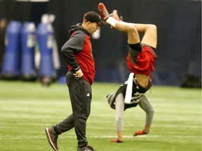Ottawa Redblacks coach Rick Campbell looks at Jeff Richards doing a handstand at the team's practice at Monarch Park school in Toronto, Ont. on Wednesday November 23, 2016. Michael Peake/Toronto Sun/Postmedia Network