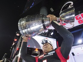 Ottawa Redblacks quarterback Henry Burris (1) lifts the Grey Cup after defeating the Calgary Stampeders in overtime CFL Grey Cup football action on Sunday, November 27, 2016 in Toronto.