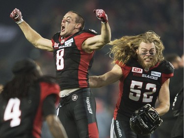 Ottawa Redblacks wide receiver Jake Harty (8) and Redblacks linebacker Tanner Doll (52) celebrate their victory over the Calgary Stampeders in overtime.