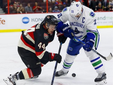 Ottawa Senators center Jean-Gabriel Pageau (44) and Vancouver Canucks center Henrik Sedin (33) battle after a faceoff at Canadian Tire Centre in Ottawa on Thursday November 3, 2016. Errol McGihon/Postmedia