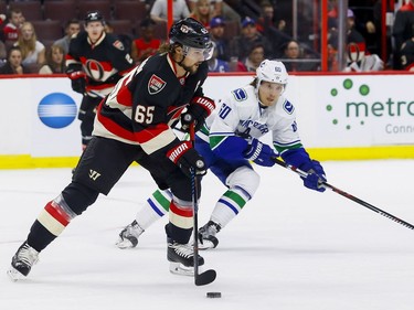 Ottawa Senators defenseman Erik Karlsson (65) eludes the check of Vancouver Canucks center Markus Granlund (60) at Canadian Tire Centre in Ottawa on Thursday November 3, 2016. Errol McGihon/Postmedia