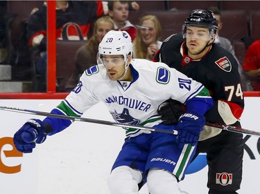 Ottawa Senators defenseman Mark Borowiecki (74) checks Vancouver Canucks center Brandon Sutter (20) at Canadian Tire Centre in Ottawa on Thursday November 3, 2016. Errol McGihon/Postmedia