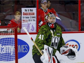 Ottawa Senators fans display a sign of support to Ottawa Senators goalie Craig Anderson (41) during warmup on the 13th annual Canadian Forces Appreciation Night at Canadian Tire Centre before taking on the Carolina Hurricanes on Tuesday November 1, 2016. Anderson's wife Nicholle Anderson waas recently diagnosed with cancer. Errol McGihon/Postmedia