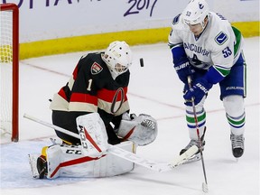 Ottawa Senators goalie Mike Condon (1) makes a save off of Vancouver Canucks center Bo Horvat (53) at Canadian Tire Centre in Ottawa on Thursday November 3, 2016. Errol McGihon/Postmedia