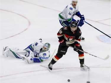 Ottawa Senators left wing Mike Hoffman (68) tracks a loose puck against Vancouver Canucks goalie Jacob Markstrom (25) and Erik Gudbranson at Canadian Tire Centre in Ottawa on Thursday November 3, 2016. Errol McGihon/Postmedia