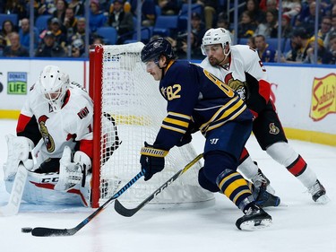 Marcus Foligno #82 of the Buffalo Sabres is stopped by Mike Condon #1 of the Ottawa Senators as Cody Ceci #5 of the Ottawa Senators defends during the second period at the KeyBank Center on November 9, 2016 in Buffalo, New York.