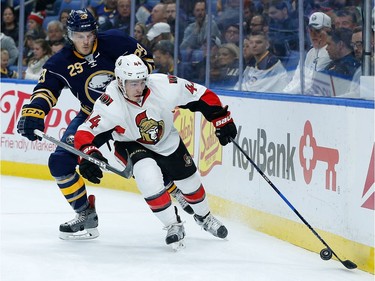 Jean-Gabriel Pageau #44 of the Ottawa Senators with the puck behind the net as Jake McCabe #29 of the Buffalo Sabres pursues during the first period at the KeyBank Center on November 9, 2016 in Buffalo, New York.