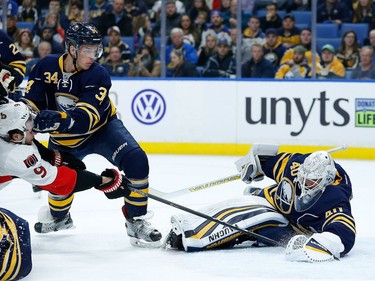 Robin Lehner #40 of the Buffalo Sabres makes a save on a shot by Bobby Ryan #9 of the Ottawa Senators as Casey Nelson #34 of the Buffalo Sabres defends during the first period at the KeyBank Center on November 9, 2016 in Buffalo, New York.