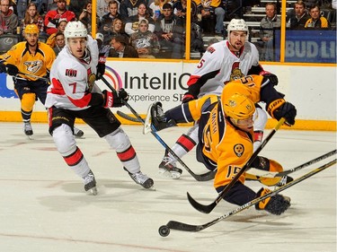 NASHVILLE, TN - NOVEMBER 08:  Craig Smith #15 of the Nashville Predators falls in front of Kyle Turris #7 of the Ottawa Senators during the first period at Bridgestone Arena on November 8, 2016 in Nashville, Tennessee.