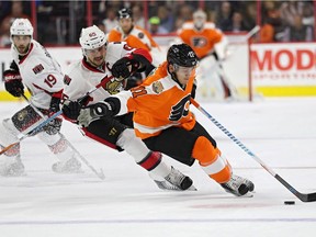 Travis Konecny #11 of the Philadelphia Flyers skates past Erik Karlsson #65 of the Ottawa Senators with the puck during the second period at Wells Fargo Center on November 15, 2016 in Philadelphia, Pennsylvania.