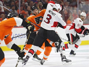 Dale Weise #22 of the Philadelphia Flyers is checked by Marc Methot #3 of the Ottawa Senators during the first period at Wells Fargo Center on November 15, 2016 in Philadelphia, Pennsylvania.