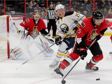 Ottawa's Codi Ceci (right) keeps the puck from Buffalo's Jack Eichel in front of Anderson's net during second-period action between the Ottawa Senators and the Buffalo Sabres Tuesday (Nov. 29, 2016) at the Canadian Tire Centre in Ottawa. Julie Oliver/Postmedia