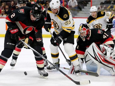 Ottawa's Dion Phaneuf (left) keeps the puck from Boston's Matt Beleskey around Craig Anderson's net induring first-period action of the Ottawa Senators matchup against the Boston Bruins Thursday (Nov.4, 2016) at Canadian Tire Centre in Ottawa.