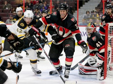 Ottawa's Marc Methot battles to keep the puck out of Craig Anderson's crease during third-period action of the Ottawa Senators matchup against the Boston Bruins Thursday (Nov.4, 2016) at Canadian Tire Centre in Ottawa.