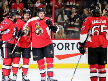 Ottawa's Mike Hoffman (second from left) is congratulated by teammates for his hat trick during third-period action between the Ottawa Senators and the Buffalo Sabres Tuesday (Nov. 29, 2016) at the Canadian Tire Centre in Ottawa. Despite that, Buffalo still beat the Sens 5-4. Julie Oliver/Postmedia