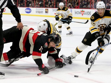 Ottawa's Zack Smith trips over Boston's Matt Beleskey as Boston's  David Pasternak (right) gets the puck during first-period action of the Ottawa Senators matchup against the Boston Bruins Thursday (Nov.4, 2016) at Canadian Tire Centre in Ottawa.