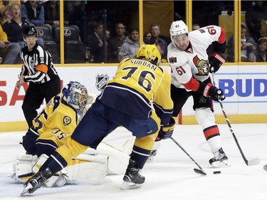 Ottawa Senators right wing Mark Stone (61) and Nashville Predators defenseman P.K. Subban (76) reach for a rebound in front of goalie Pekka Rinne (35), of Finland, during the first period of an NHL hockey game Tuesday, Nov. 8, 2016, in Nashville, Tenn.