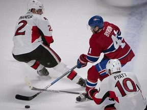 Montreal Canadiens' Paul Byron, centre, squeezes between Ottawa Senators' Dion Phaneuf, left, and Ottawa Senators' Tom Pyatt during first period NHL hockey action in Montreal, Tuesday, November 22, 2016.
