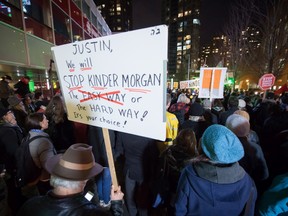 People listen during a protest against the Kinder Morgan Trans Mountain Pipeline expansion project, in Vancouver, B.C., on Tuesday November 29, 2016. THE CANADIAN PRESS/Darryl Dyck