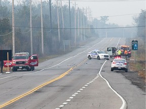 Police prepare to tow away vehicles involved in a rollover accident on West Hunt Club Rd just west of HWY 416