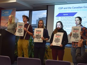 Protesters mounted the stage at Catherine McKenna breakfast talk at COP22 on Nov. 1 to quietly protest the proposed Kinder Morgan pipeline.