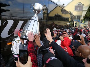 Rick Campbell, Head Coach of the Ottawa Redblacks, shows off the Grey Cup as his team arrives at TD Place and were welcomed by fans, November 28, 2016.