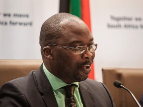 South African Justice Minister Michael Masutha gives a press briefing in Pretoria on October 21, 2016 regarding South Africa's decision to withdraw from the International Criminal Court (ICC). South Africa announced on October 21 that it is withdrawing from the ICC, dealing a major blow to a troubled institution set up to try the world's worst crimes. South Africa's decision followed a dispute last year when Sudanese President Omar al-Bashir visited the country for an African Union summit despite facing an ICC arrest warrant over alleged war crimes. Justice Minister Michael Masutha told reporters in Pretoria that the court was "inhibiting South Africa's ability to honour its obligations relating to the granting of diplomatic immunity". /