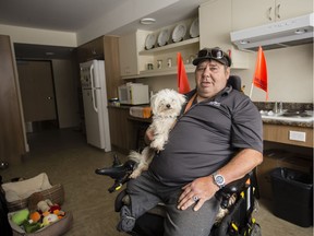 Salus resident Michael Backs and his dog, Reggie, in his apartment on Clementine Boulevard.
