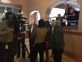 Reporters scrum city real estate director Gordon MacNair.