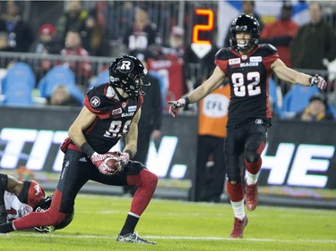 Ottawa Redblacks wide receiver Brad Sinopoli (left) celebrates a touchdown with teammate Greg Ellingson (82) against the Calgary Stampeders during third quarter CFL Grey Cup action Sunday, November 27, 2016 in Toronto.