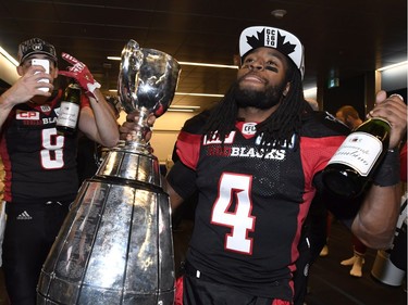 Ottawa Redblacks wide receiver Jamill Smith (4) holds the Grey Cup and a bottle of champagne as he celebrates his team's Grey Cup win over the Calgary Stampeders in Toronto on Sunday, November 27, 2016.