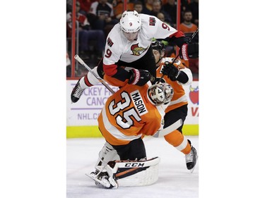 Ottawa Senators' Bobby Ryan (9) collides with Philadelphia Flyers' Steve Mason (35) during the first period of an NHL hockey game, Tuesday, Nov. 15, 2016, in Philadelphia.