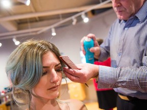Rocky Couture, co-owner of Scissors Hair Salons since 1981, adds a temporary spray-on colour in strawberry blush from Schwarzkopf Professional for a touch of fun during the festive holiday season. Kimberly Anne Labonte is dressed in a blue sequin and blush-coloured sleeveless beaded gown by Aidan Mattox from Rent Frock Repeat. The Canadian company, located on Murray Street in the ByWard Market next to Scissors, provides designer dress rentals for both casual and formal events at up to 90 per cent off their retail price.