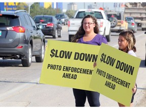 Photo radar in different Canadian cities has elicited different reactions. Here, supporters of WiseUp Winnipeg hold placards in that city in 2014.