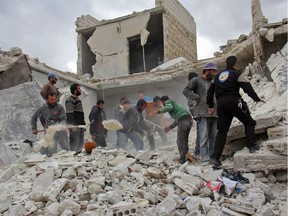 Rescuers and civilians inspect a destroyed building in the Syrian village of Kfar Jales, on the outskirts of Idlib, following air strikes by Syrian and Russian warplanes on Nov. 16. Barack Obama has stood by, and now Donald Trump will too.