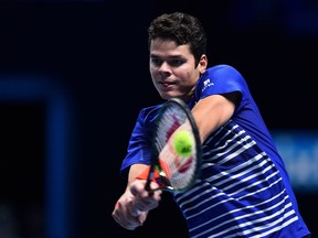 Canada's Milos Raonic returns against Britain's Andy Murray during their men's semi-final singles match on day seven of the ATP World Tour Finals tennis tournament in London on November 19, 2016. /