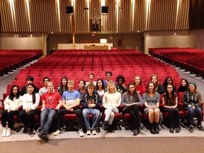 The cast and crew of The Addams Family musical pose at Woodroffe High School, in the new auditorium seats formerly belonging to the National Arts Centre. (Photo by Heather Esdon)