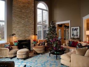 This cozy family room off the kitchen/dining area features extra high ceilings and a stunning holiday tree.