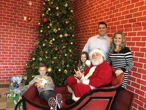The Noonan family: (L to R) Damon, Makiya, Craig and Kristin with Santa at the Signing Santa event at Funhaven Nov. 26, 2016.