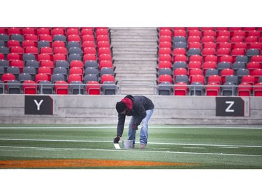 Crews were on the field Saturday, a day before the East final, getting the lines painted in preparation for the game Sunday.