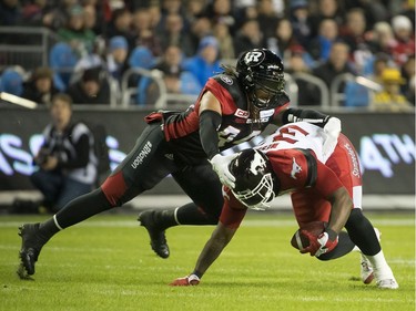 TORONTO, ONTARIO: NOVEMBER 27, 2016--GREY CUP--Calagary Stampeders player Jerome Messam scarmbles for yardage as Ottawa RedBlack player Taylor Reed makes the tackle during first half action of the 104th Grey Cup at Toronto's BMO Field, Sunday November 27, 2016.                                                                                                                                                                                                                                                                                                                                                                                                                              [Photo Peter J Thompson] [For National story by Scott Stinson/National]