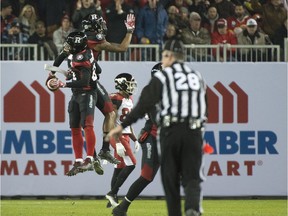 File photo/ Ottawa RedBlacks players Forrest Hightower and Jeff Richards celebrate a play over the Calgary Stampeders during the 104th Grey Cup. November 27, 2016.
