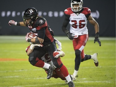 TORONTO, ONTARIO: Sunday, November 27, 2016 - Ottawa Redblacks Kienan Lafrance is tackled by Calgary Stampeders Alex Singleton during the second quarter of the 104th CFL Grey Cup between the Calgary Stampeders and the Ottawa Redblacks at BMO Field in Toronto, Ontario on Sunday, November 27, 2016.  (Laura Pedersen/National Post)  (For Sports story by TBA)   //NATIONAL POST STAFF PHOTO