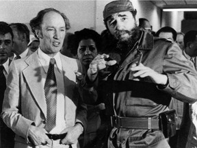 Pierre Trudeau looks on as Cuban President Fidel Castro gestures during a visit to a Havana housing project in this Jan. 27, 1976 photo