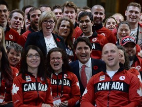 Prime Minister Justin Trudeau poses with Canadian Olympic and Paralympic athletes in the Hall of Honour on Parliament Hill in Ottawa on Wednesday, November 2, 2016.