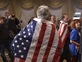 Flag-drapped supporters of Republican presidential nominee Donald Trump attend a rally at the Atkinson Country Club in Atkinson, New Hampshire on November 4, 2016. /