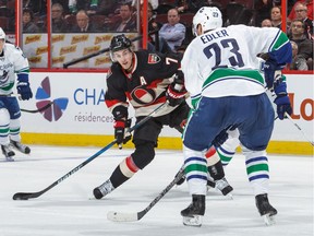 Kyle Turris #7 of the Ottawa Senators fires the puck against Alexander Edler #23 of the Vancouver Canucks during an NHL game at Canadian Tire Centre on November 3, 2016 in Ottawa.